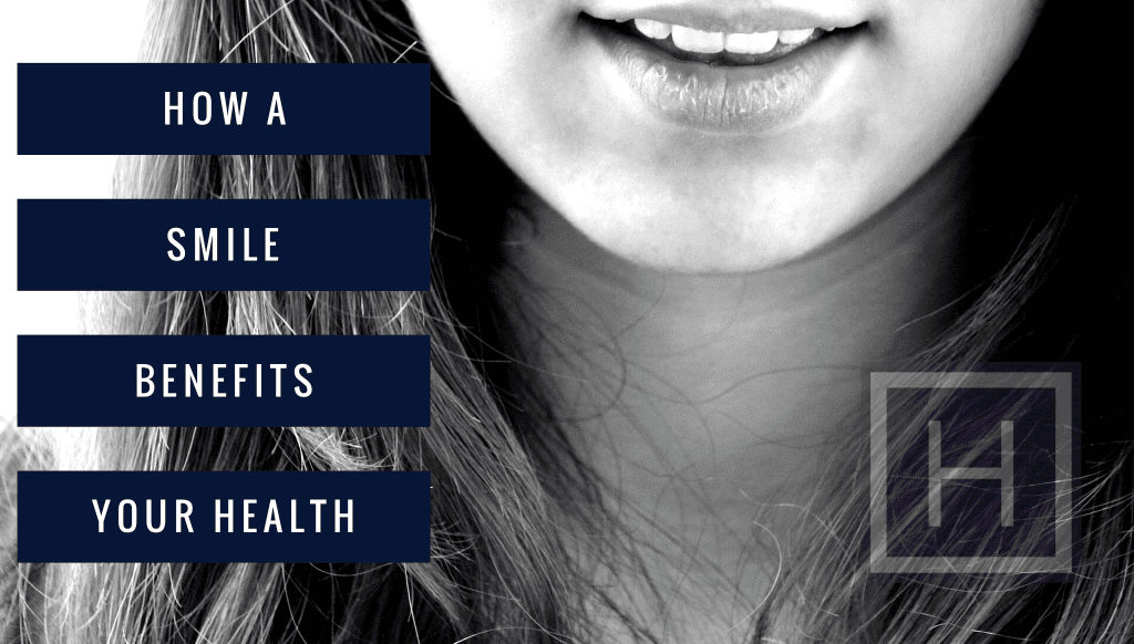 Smiling woman with bright teeth in black and white, close-up of mouth highlighting dental health and smile benefits.
