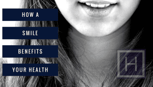 Smiling woman with bright teeth in black and white, close-up of mouth highlighting dental health and smile benefits.