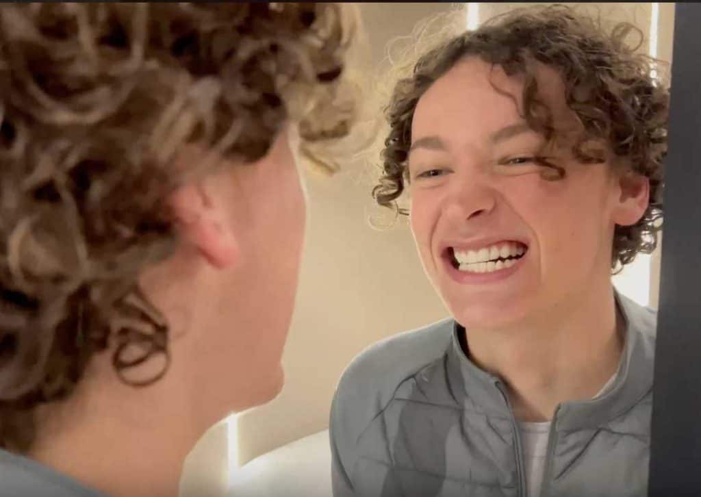 Bright young man smiling during a dental consultation at Hewett's Dental clinic.