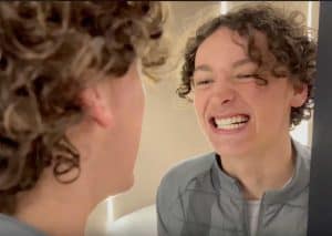 Bright young man smiling during a dental consultation at Hewett's Dental clinic.